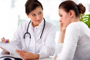 doctor explaining diagnosis to her female patient