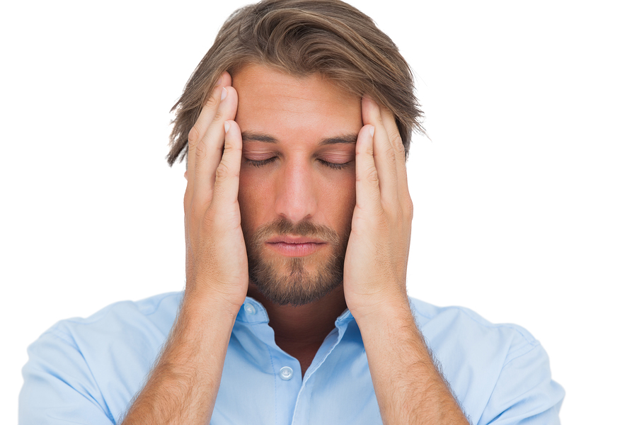 Man touching his temples to calm a headache on white background